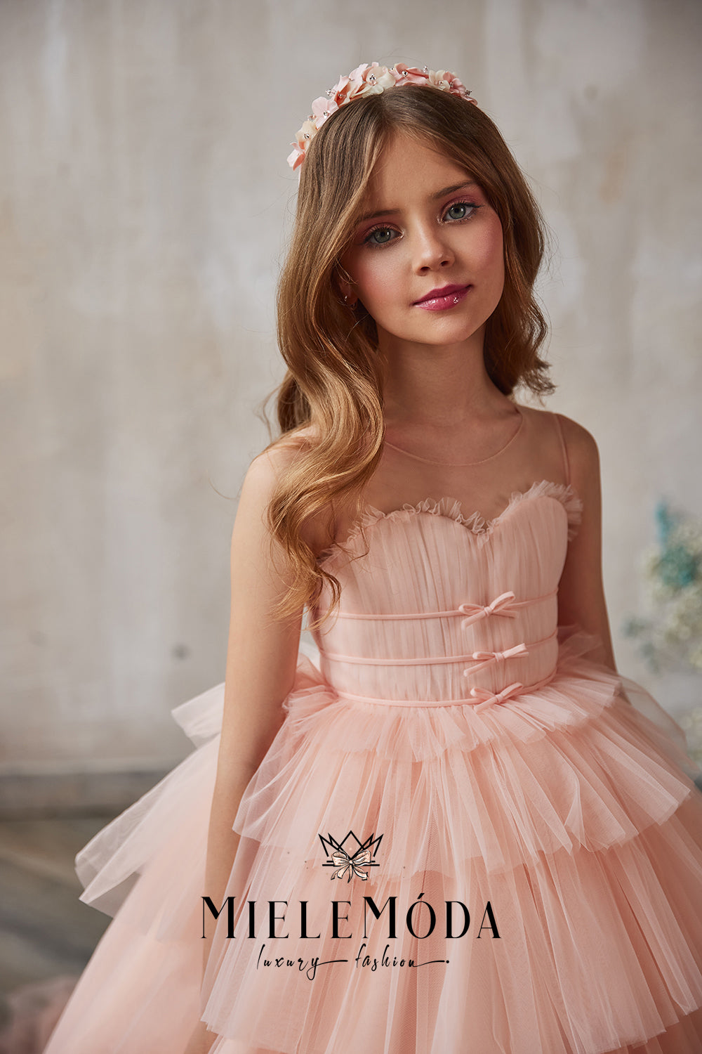 pretty girl with blue eyes wearing gorgeous pink tulle couture dress from miele moda fashion boutique