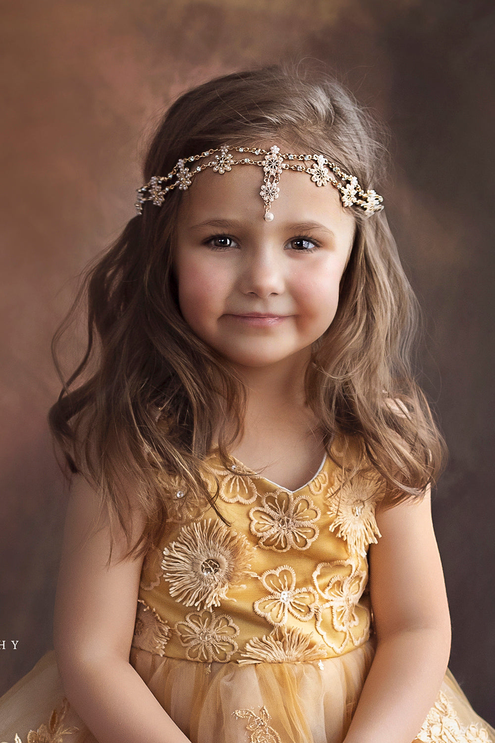 Pretty girl wearing Majesty Teardrop Gold Flowers Girl Headband-by Miele Moda Boutique