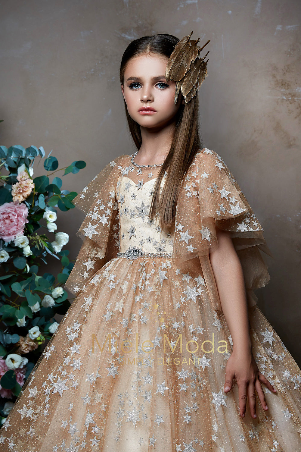 Pretty girl wearing Stellara Sparkly Stars Flower Girl Dress-by Miele Moda Boutique